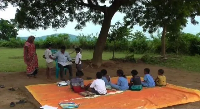 ଗଛ ମୂଳେ ଚାଲିଛି ଭବିଷ୍ୟତ ଗଢା ! ସ୍କୁଲ ଘର ନଥିବାରୁ ଖୋଲା ଆକାଶ ତଳେ ପାଠପଢୁଛନ୍ତି କୁନି କୁନି ପିଲା