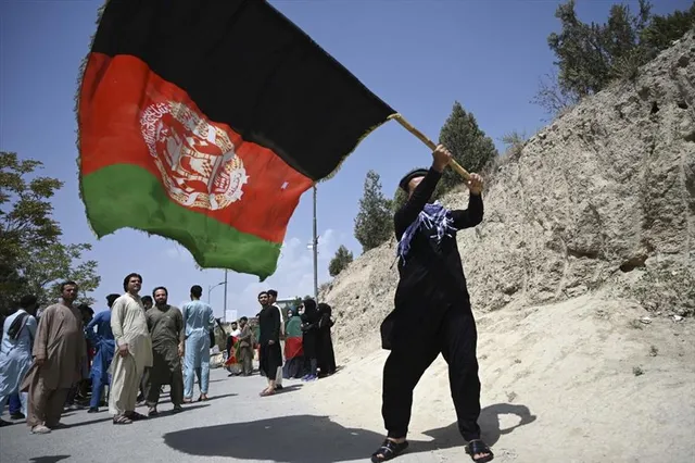 Taliban to change Afghan flag, residents defiant