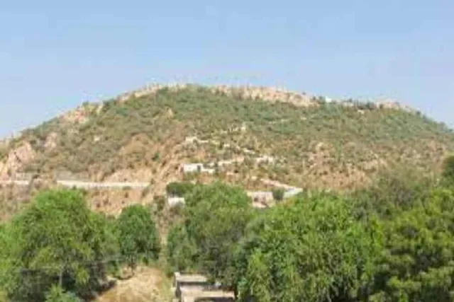 What Krishnadasa Kaviraja Goswami said about the shape of Govardhana hill?