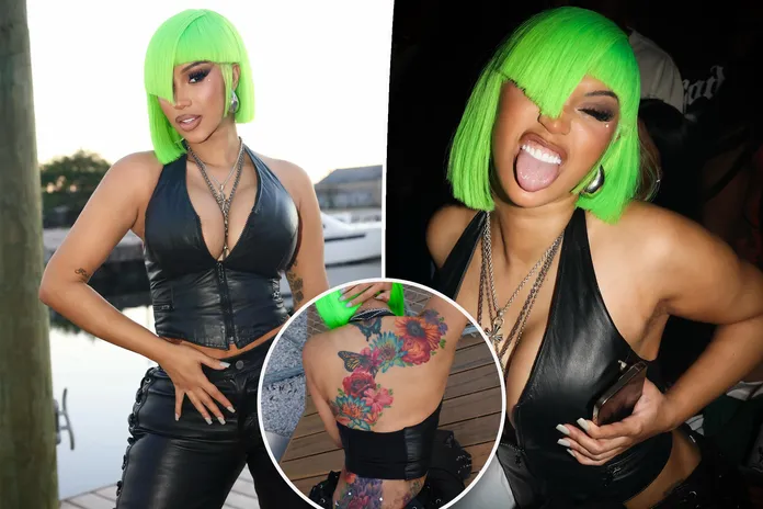 Cardi B shows off new neck and back dermal piercings in plunging second-skin  leather look