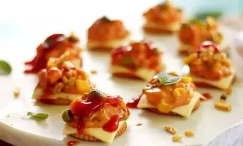 Cheesy Monacos Recipe: Try this simple recipe by adding a punch of cheese, spice and herbs layered