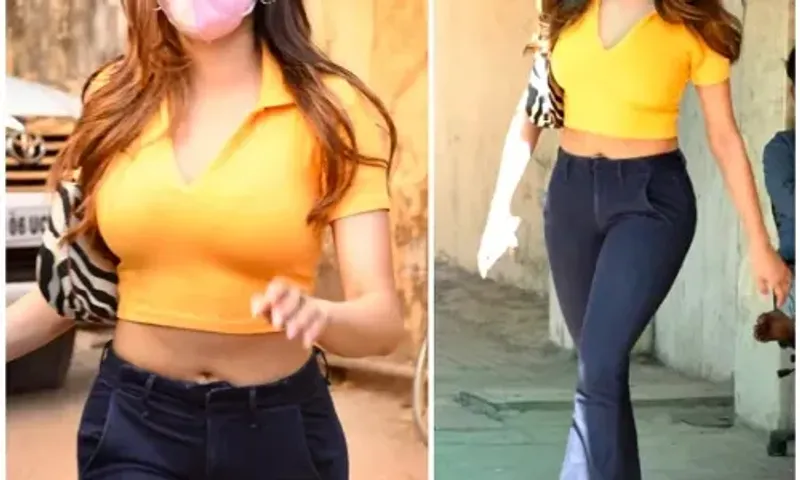 Jahanvi Kapoor keeps her OOTD simple yet bright in yellow with a crop top & bootcut jeans