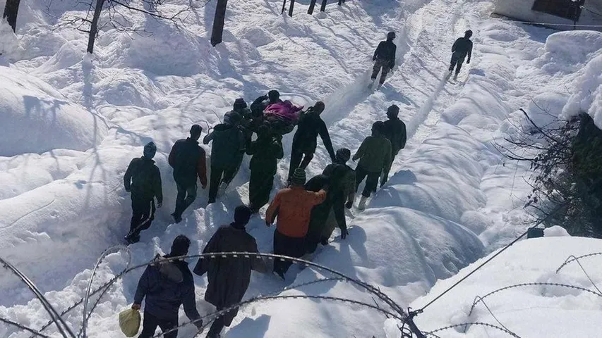 Indian army rescues a civilian half buried under snow in Kashmir