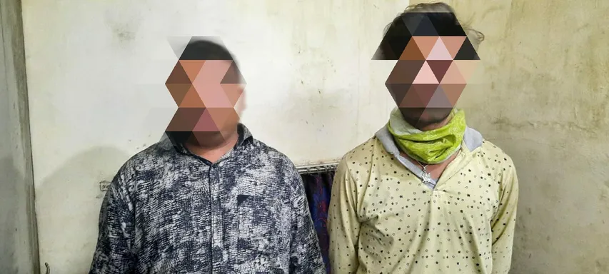Two persons were caught with liquor hidden in a hidden pocket of a vehicle