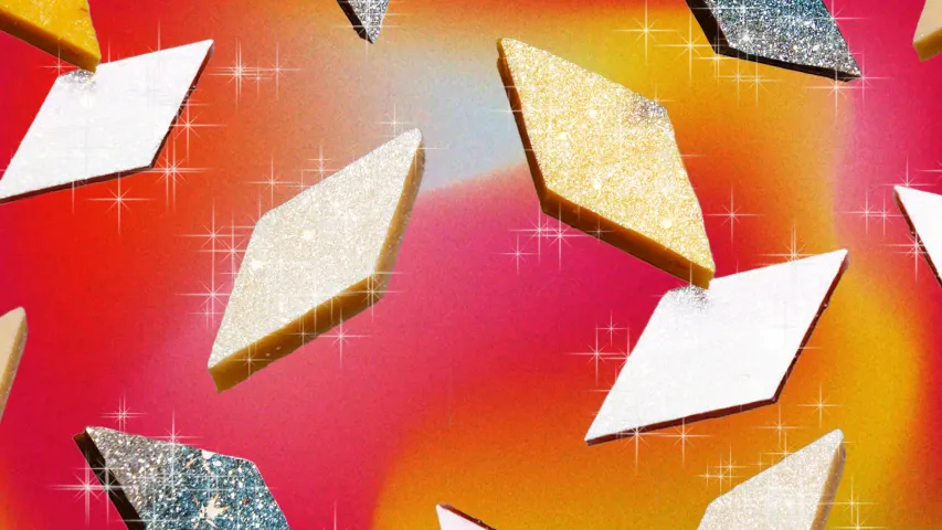 A picture of pieces of Kaju Katli shining and glittering to depict how Kaju Katli in India is considered a premium Indian mithai, which is why Kaju Katli is popular in the Indian sweet culture