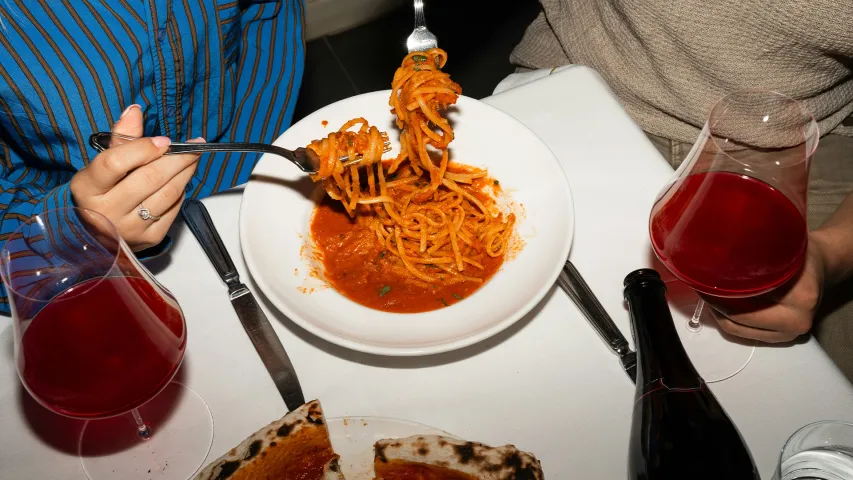 A picture of a person eating pasta to depict Italian cuisine in India and the evolution of Italian food in India, including Italian food adaptation in India and how Indianised Italian food is so far from authentic Italian food in India, which is just pizza and pasta in India