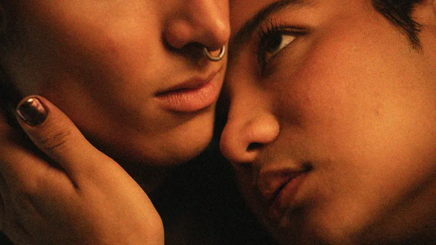 A picture of two people getting intimate to show how being a queer late bloomer is common besides first queer relationship in adulthood due to societal norms and coming out later in life