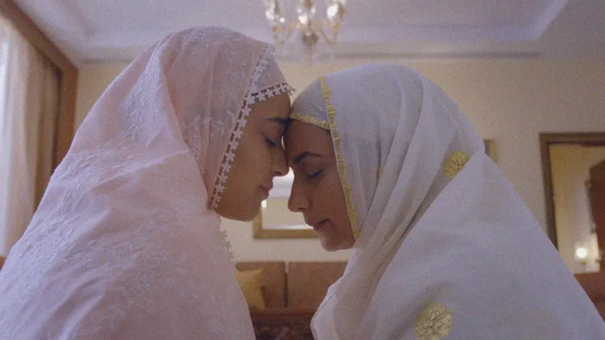 A still from a film with two women in white to depict how queer filmmakers in India and LGBTQ filmmakers India are making themselves visible in queer cinema India resulting in an increase n queer representation in Indian cinema