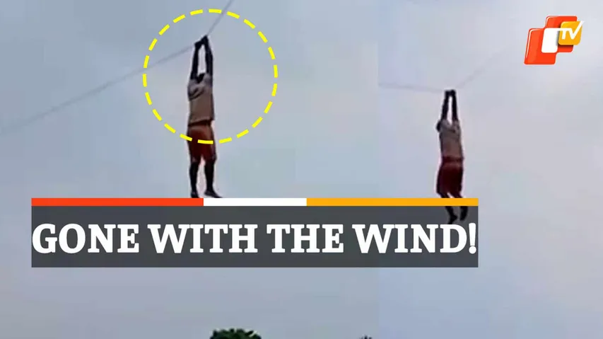 Man Hangs On Kite