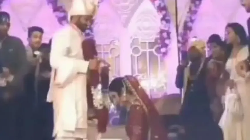 Bride goes down on her knees during ‘varmala’ ritual, viral video wins heart