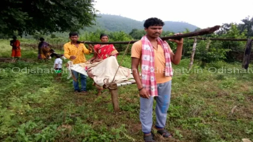 Sans roads, expectant mother carried on cot yet again!