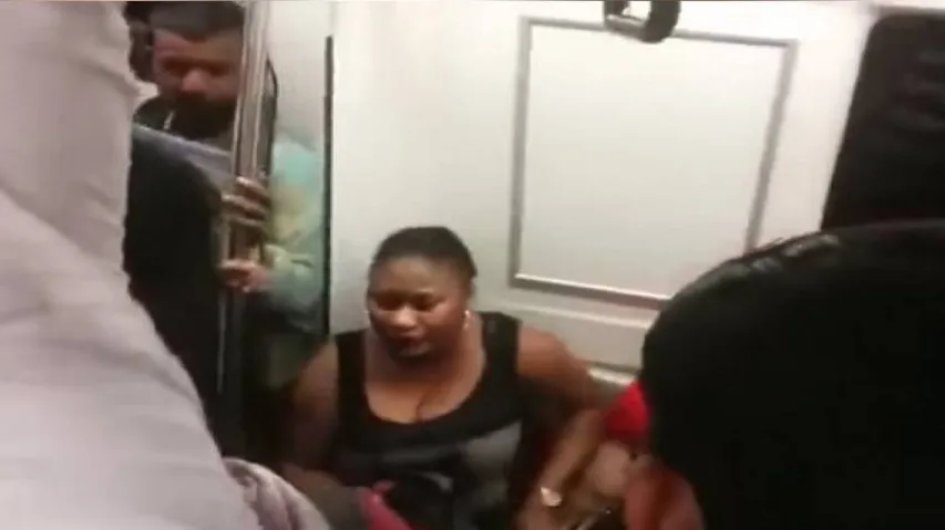 African woman takes off shirt for seat in Delhi metro
