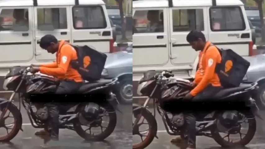 Rain not romantic for all! Tired food delivery guy takes a cat nap at traffic while getting drenched