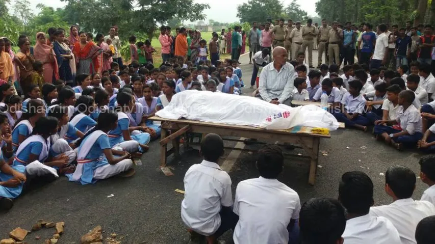Teacher dies after being hit by police vehicle, students block road