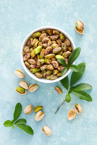pistachios-pistachio-nuts-with-green-leaves-heal-2023-11-27-05-10-26-utc (1)