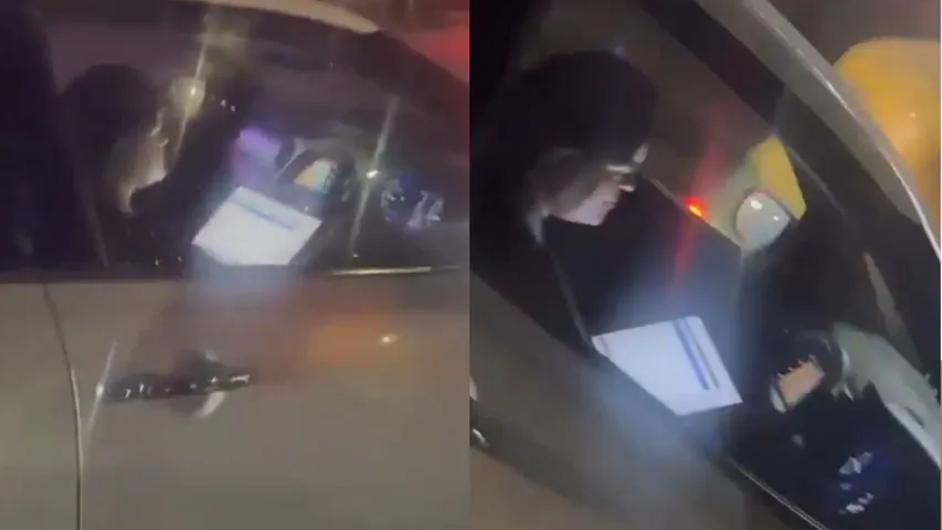 Bengaluru woman working on a laptop while driving.