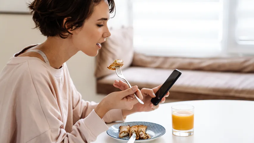 eating food and watching mobile