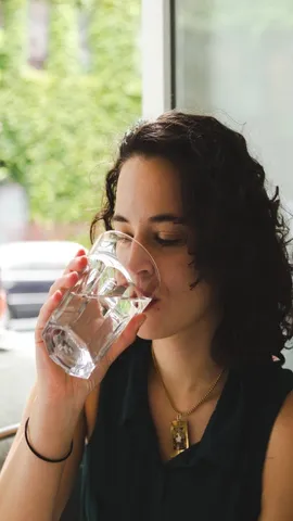 beautiful-young-millennial-woman-drinking-a-glass-2025-01-07-06-15-04-utc