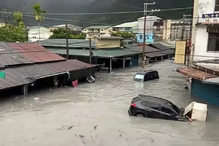 A car is seen stuck in floodwaters in Hualien