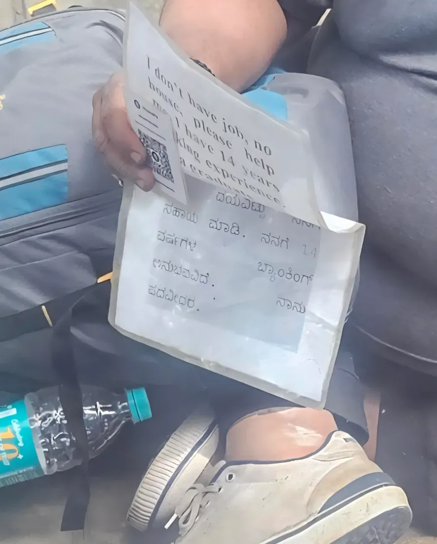 man with 14 years of experience in banking sits on footpath