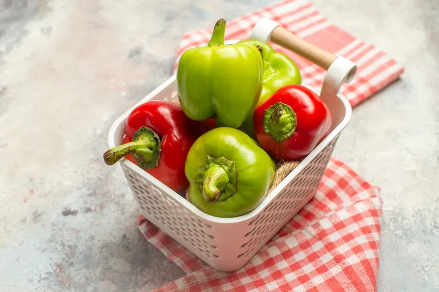 top-view-green-and-red-peppers-in-plastic-basket-r-2023-11-27-05-12-25-utc (1)