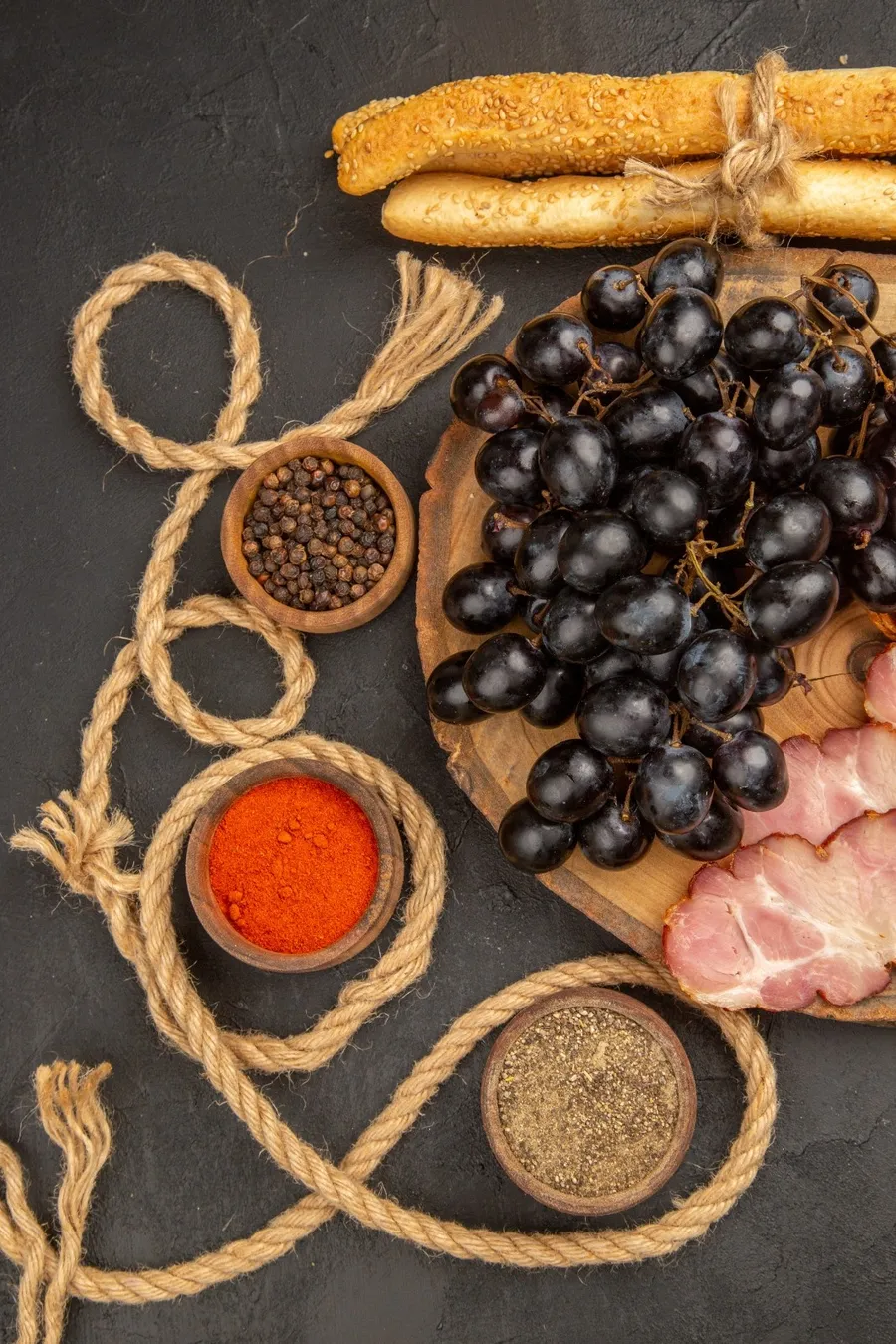 top-view-ham-slices-with-grapes-seasonings-and-bre-2023-11-27-05-33-16-utc (1)