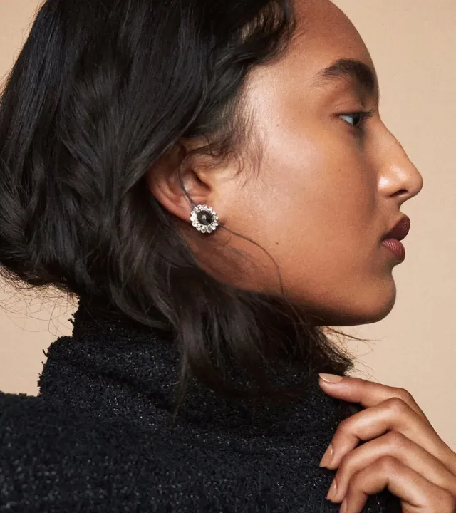 A woman's side profile picture featuring sculpted cheekbones using cream contour sticks