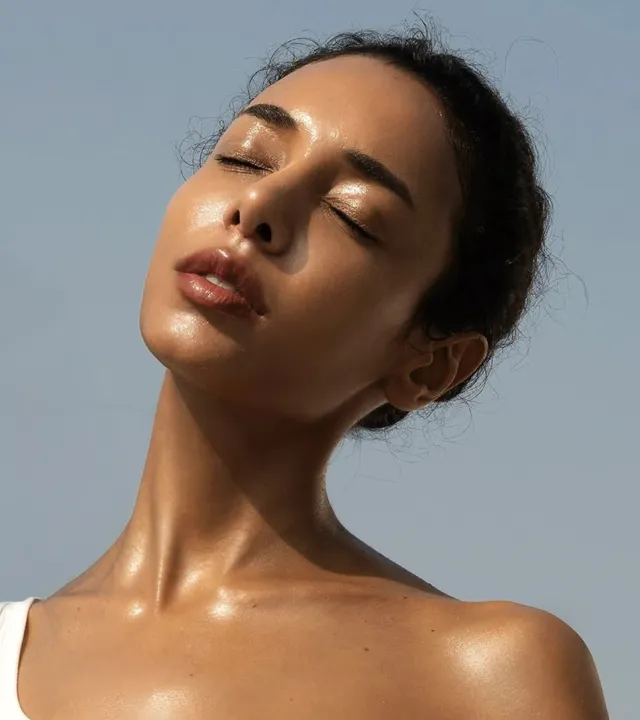 A woman with well-hydrated skin after using the best hydrating face mist