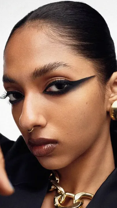 A model's face with a jet black, dramatic winged eyeliner using a Kajal pencil