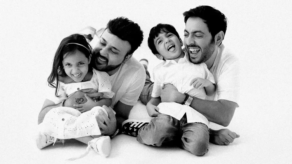 A picture of two men, with one boy and girl as a representation of queer parenting in India and the rise of same-sex couples adoption India that's increasing inclusivity and queer families