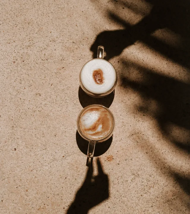 A picture of two cups of coffee--one dark, the other lighter--to represent the rise of luxury coffee brands in India, along with specialty coffee India and artisanal coffee India