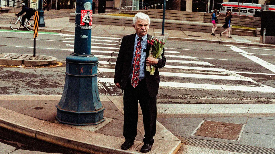 A picture of an old person standing on the pavement of a road to show how queer ageing in India can be lonely, which is when chosen family LGBTQ+ matters given how real queer loneliness India and ageing without marriage in India is, and only queer companionship can battle that