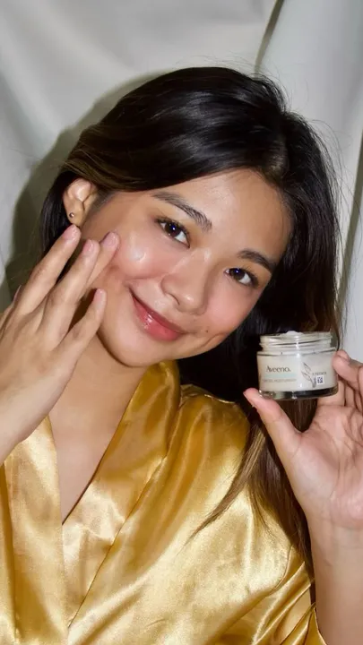 A woman applying a colloidal oatmeal cream