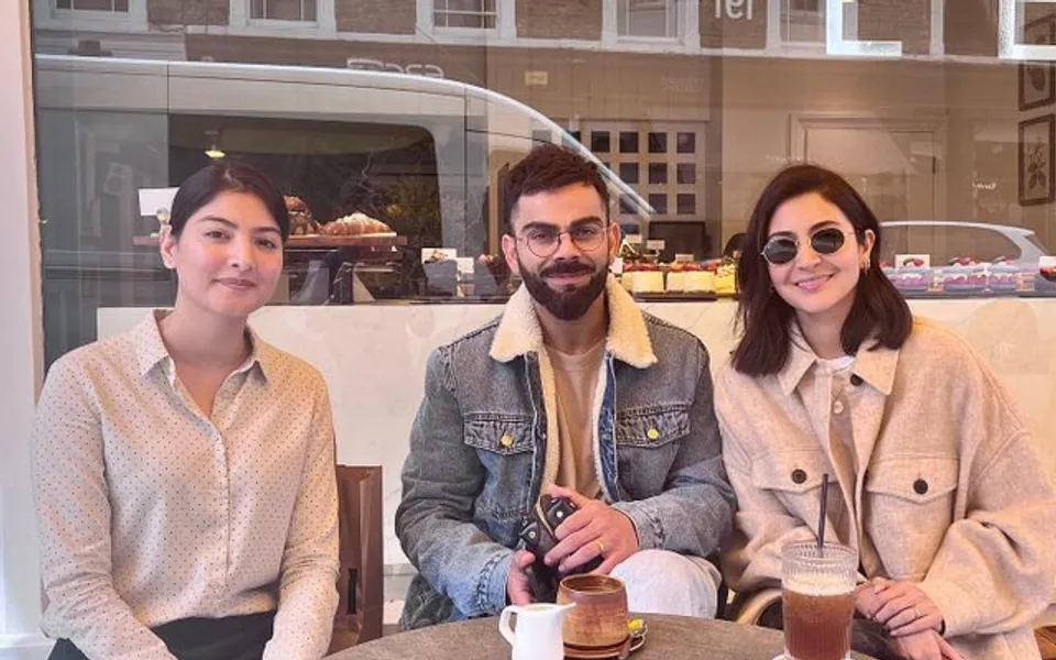 Virat Kohli and Anushka Sharma with a fan (Source - Twitter)