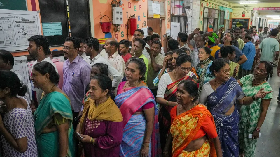 People wait to cast their votes during the 5th phase of Lok Sabha elections, in Mumbai, Monday, May 20, 2024
