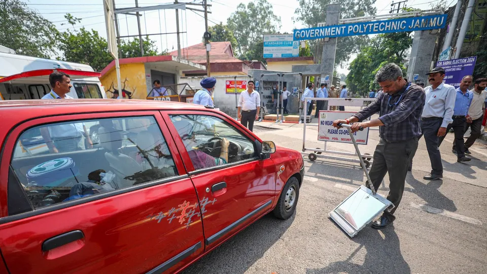 A security personnel checks a vehicle outside a counting centre, a day before counting of votes for the Lok Sabha elections, in Jammu, Monday, June 3, 2024