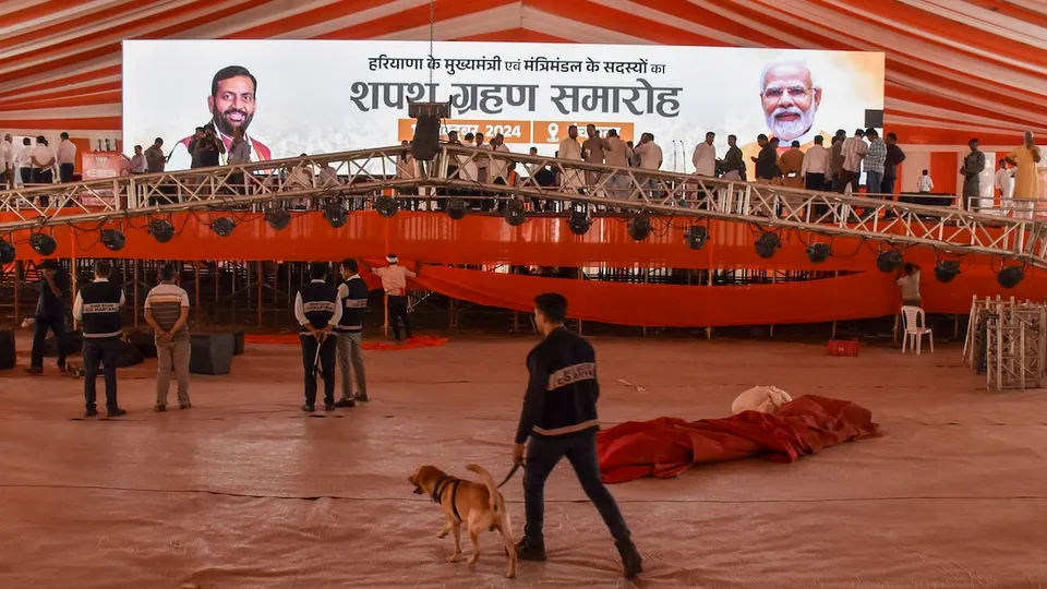 Security personnel and others during preparations for the swearing-in ceremony of the Haryana Chief Minister-elect Nayab Saini, in Panchkula, Wednesday, Oct. 16, 2024.