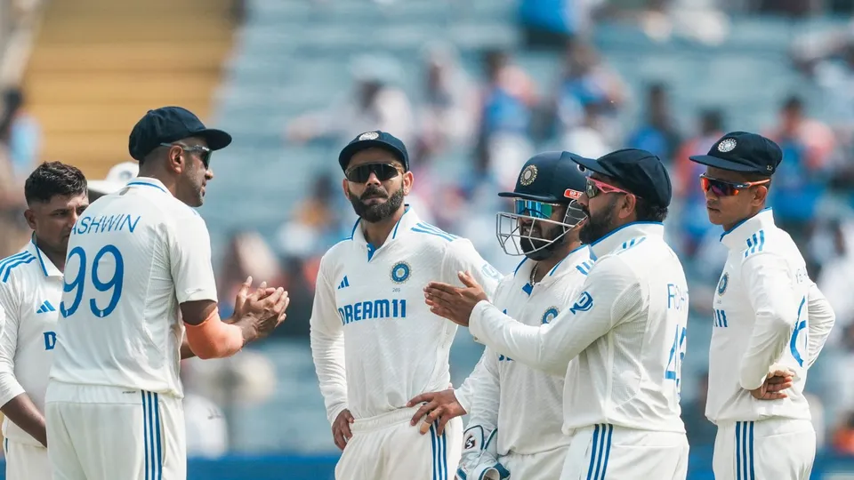 India's players wait during an unsuccessful DRS review for the wicket of New Zealand's Devon Conway,at the Maharashtra Cricket Association Stadium, in Pune, Thursday, Oct. 24, 2024.