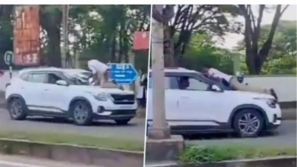 A traffic police official on duty was dragged for several metres on the bonnet of a car in Shivamogga