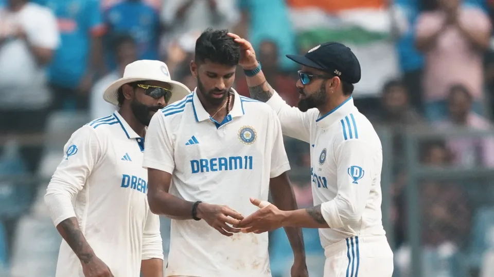 Washington Sundar with teammates Virat Kohli and Ravindra Jadeja celebrates the wicket of New Zealand's batter Tom Latham during the first day of the third Test cricket match between India and New Zealand, at Wankhede Stadium, in Mumbai, Friday, Nov. 1, 2024.
