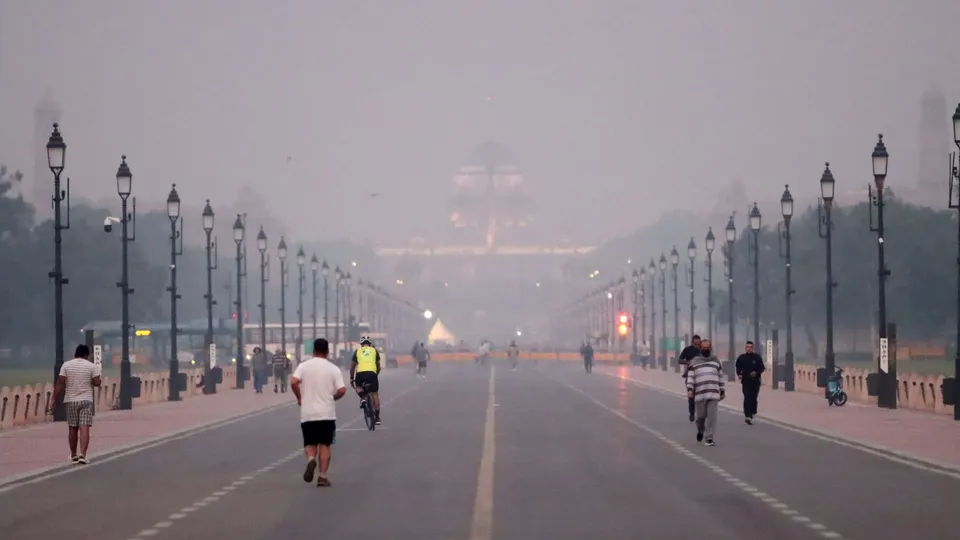 People jog at Kartavya Path as air quality continues to remain poor, in New Delhi, early Saturday morning, Nov. 2, 2024.