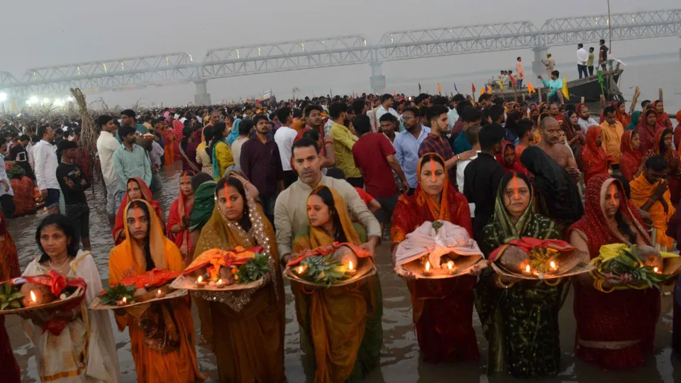 Devotees offer prayers to the rising sun at River Ganga on the last day of the Chhath Puja festival, in Patna, Friday, Nov. 8, 2024.