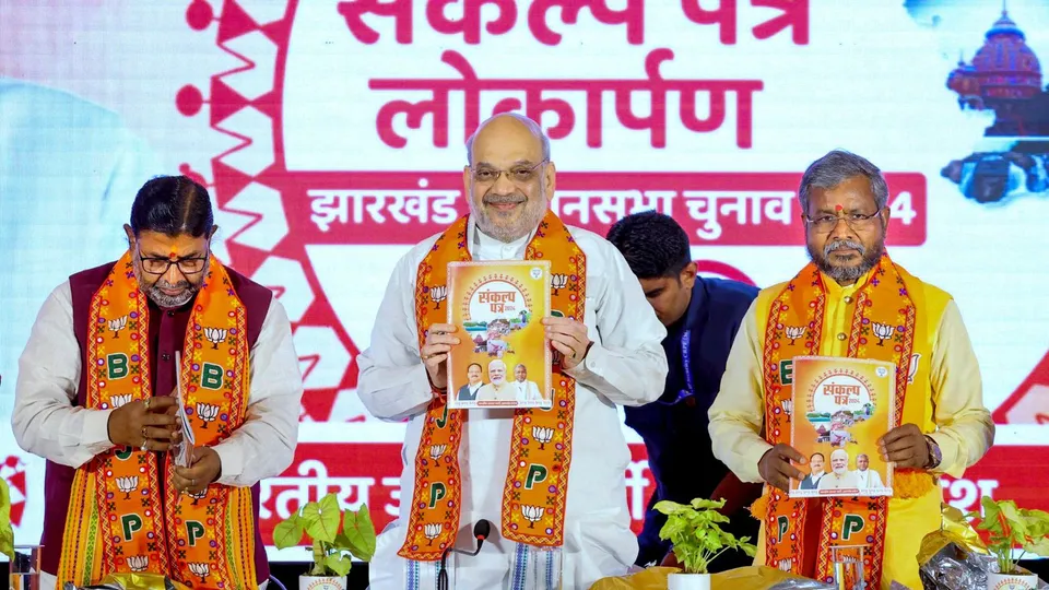 Union Home Minister and BJP leader Amit Shah with Jharkhand BJP President Babulal Marandi, former union minister Arjun Munda and others releases the party's manifesto for Jharkhand Assembly elections, in Ranchi, Sunday, Nov. 3, 2024.