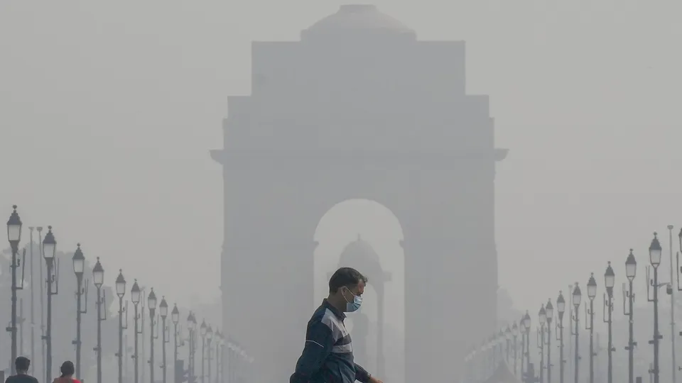 A pedestrian wearing a face mask at Kartavya Path as air quality continues to remain poor, in New Delhi