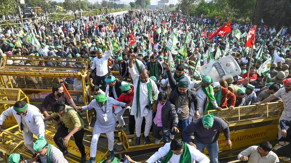 Farmers and Kisan Ekta Sangh members break police barricades during their protest march demanding for the expansion of minimum support prices (MSP) and other benefits, in Noida, Monday, Dec. 2, 2024.