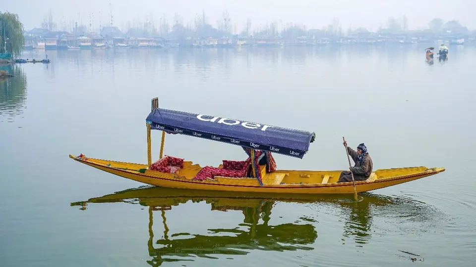 A Shikarawala sails an Uber 'Shikara' across Dal Lake, in Srinagar. Uber has launched its water transport service in India, with a booking of a shikara at Dal Lake in Srinagar through its app.