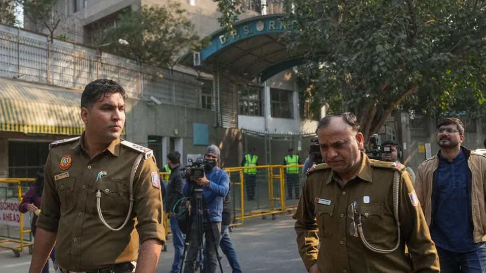 Police personnel outside DPS RK Puram during an investigation after the school received bomb threat, in New Delhi, Monday, Dec. 9, 2024.