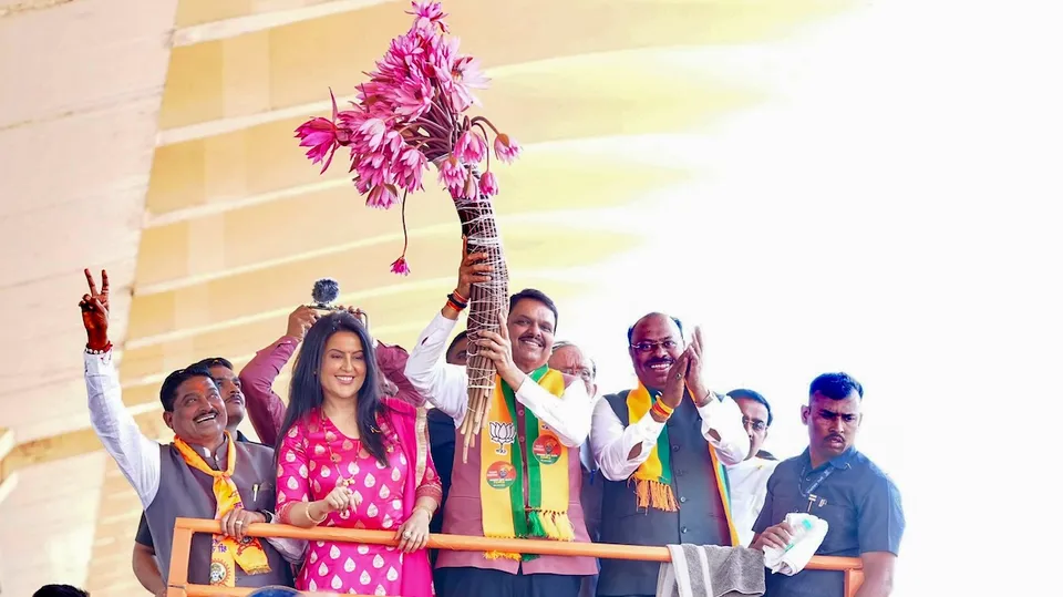 Devendra Fadnavis with his wife Amruta Fadnavis during a roadshow, in Nagpur, Sunday, Dec. 15, 2024.