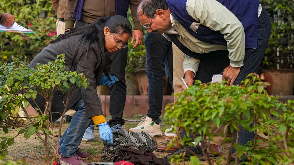 Members of the forensic team of Delhi Police Crime Branch conducts investigation at the spot where a man tried to immolate himself near the Railway Bhawan opposite the new Parliament building in New Delhi on Wednesday, Dec. 25, 2024. 