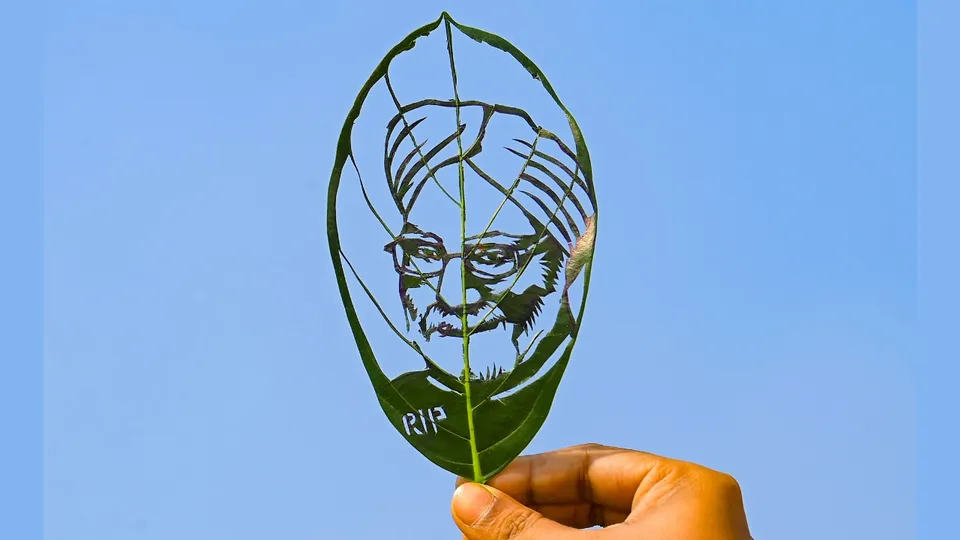 Leaf artist Subham Saha shows his artwork in Agartala on Friday, Dec. 27, 2024, paying tribute to former prime minister Manmohan Singh, who passed away on Thursday. 